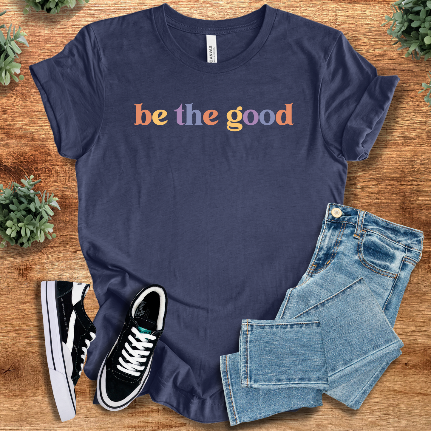 Be the Good Tee in navy with colorful text graphic. Soft unisex cotton t-shirt ideal for casual, ethical fashion and everyday wear.