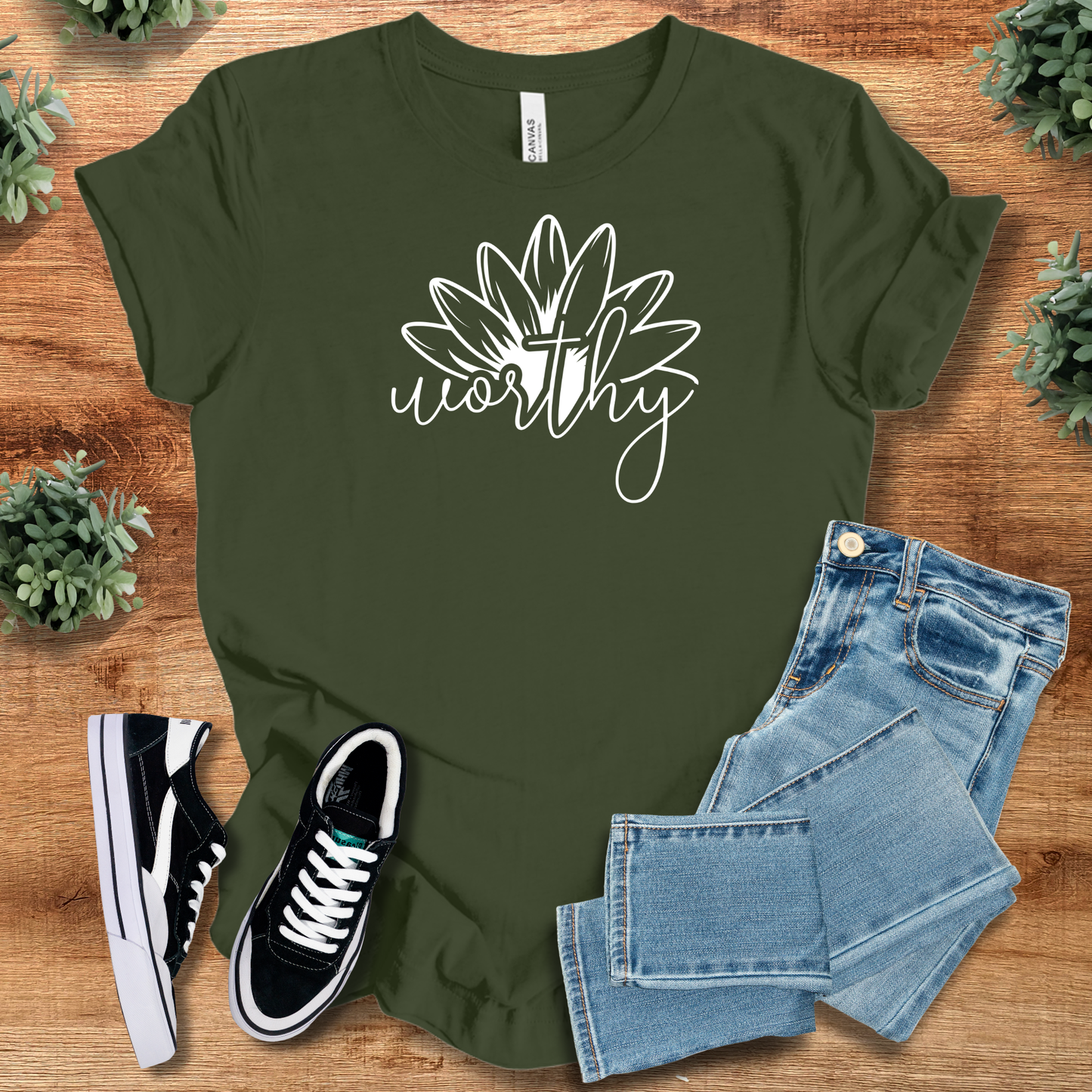Heather-aqua t-shirt with '' text, flat lay styled on a wooden surface.