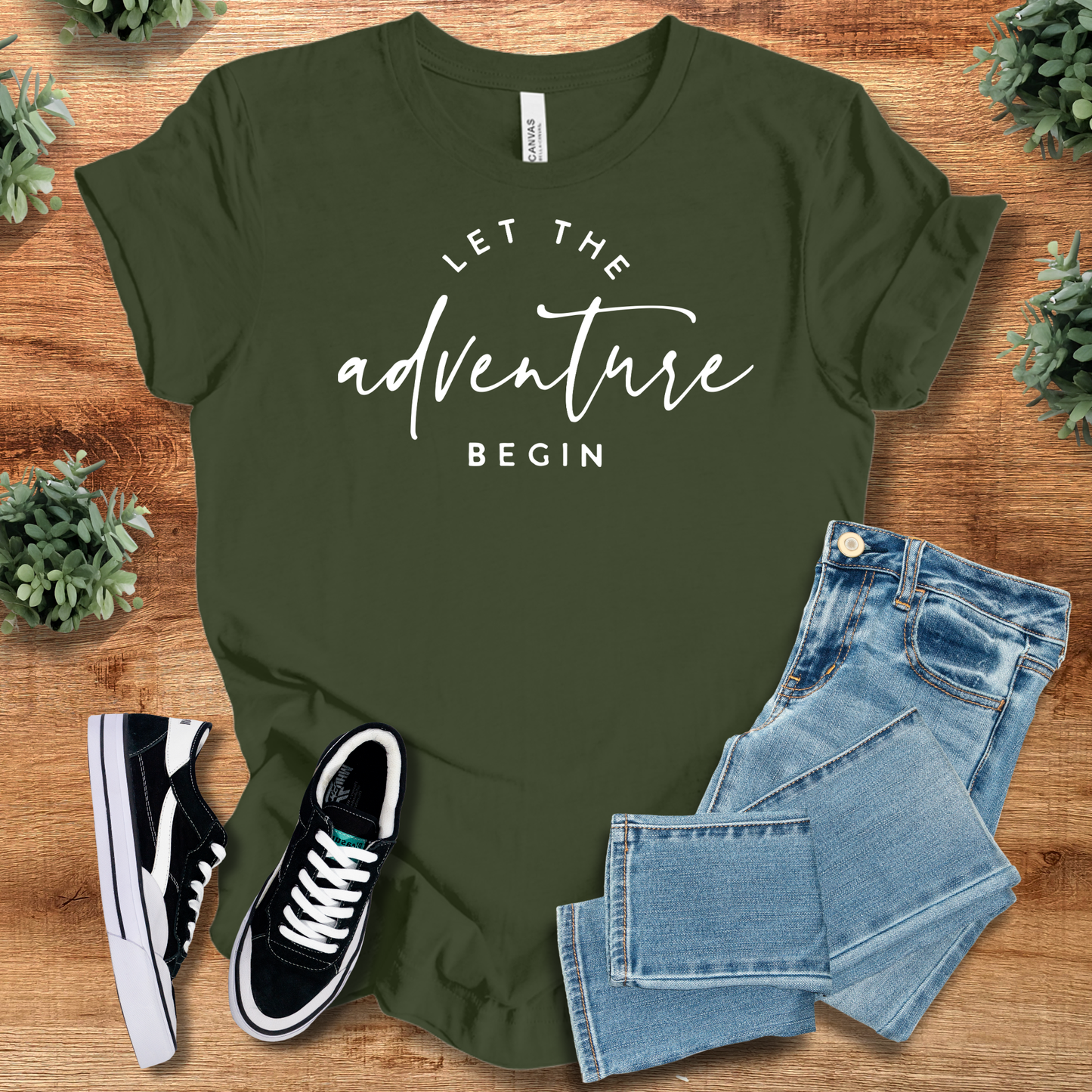 Heather-aqua t-shirt with '' text, flat lay styled on a wooden surface.