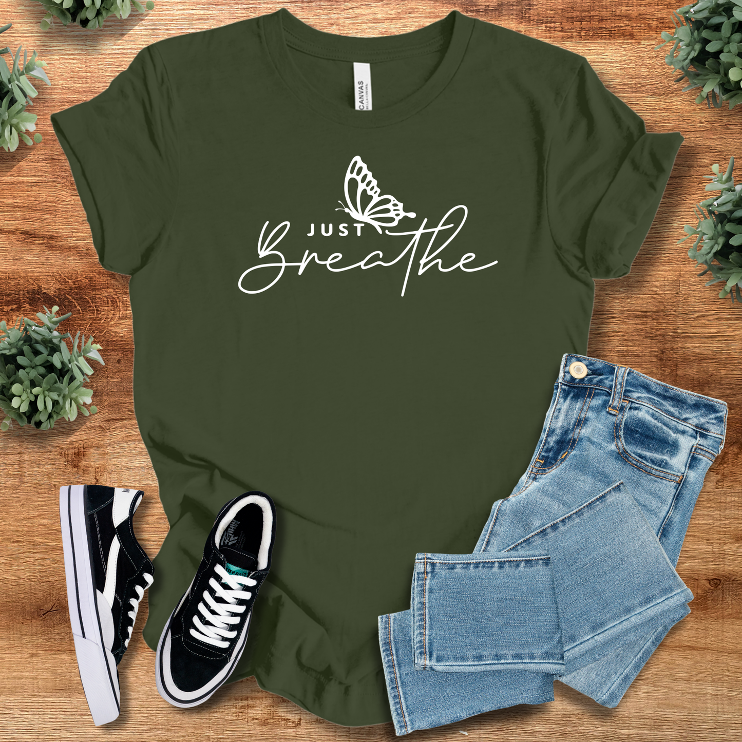 Olive green Just Breathe Tee T‑Shirt on Bella+Canvas 3001 with uplifting butterfly script, styled for everyday wear.