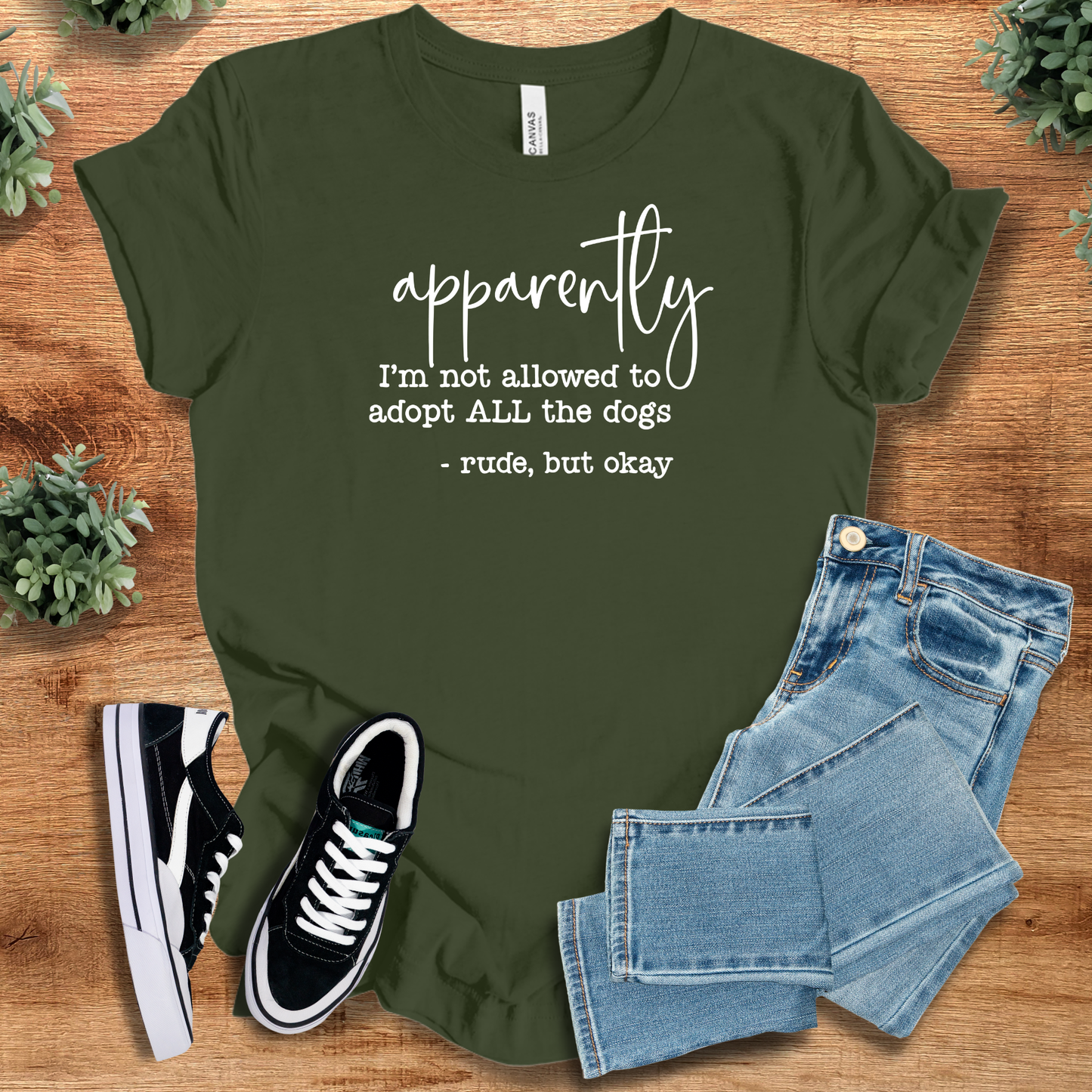 Olive green humorous dog lover t-shirt with quirky adoption message. Lightweight combed cotton tee perfect for pet parents and animal advocates.
