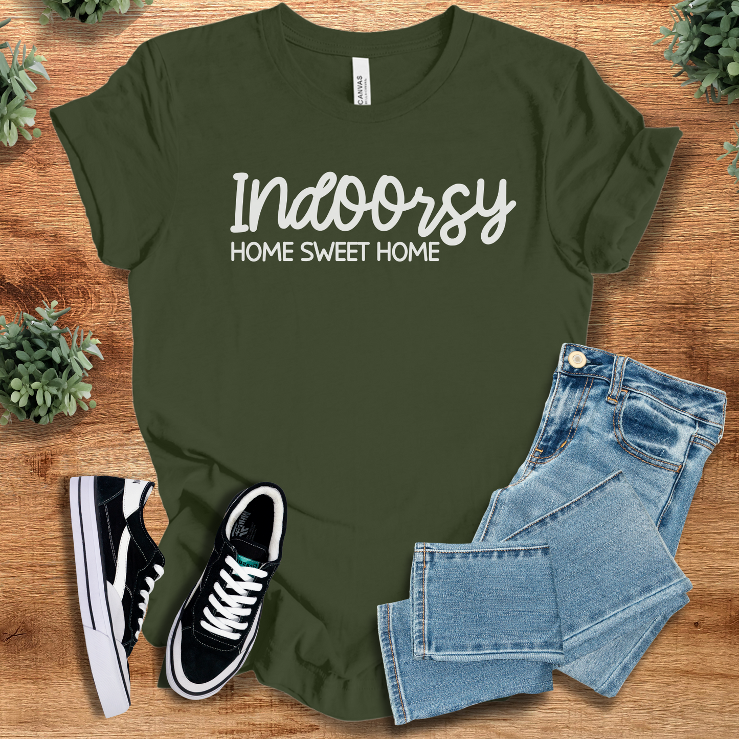 Heather-aqua t-shirt with '' text, flat lay styled on a wooden surface.