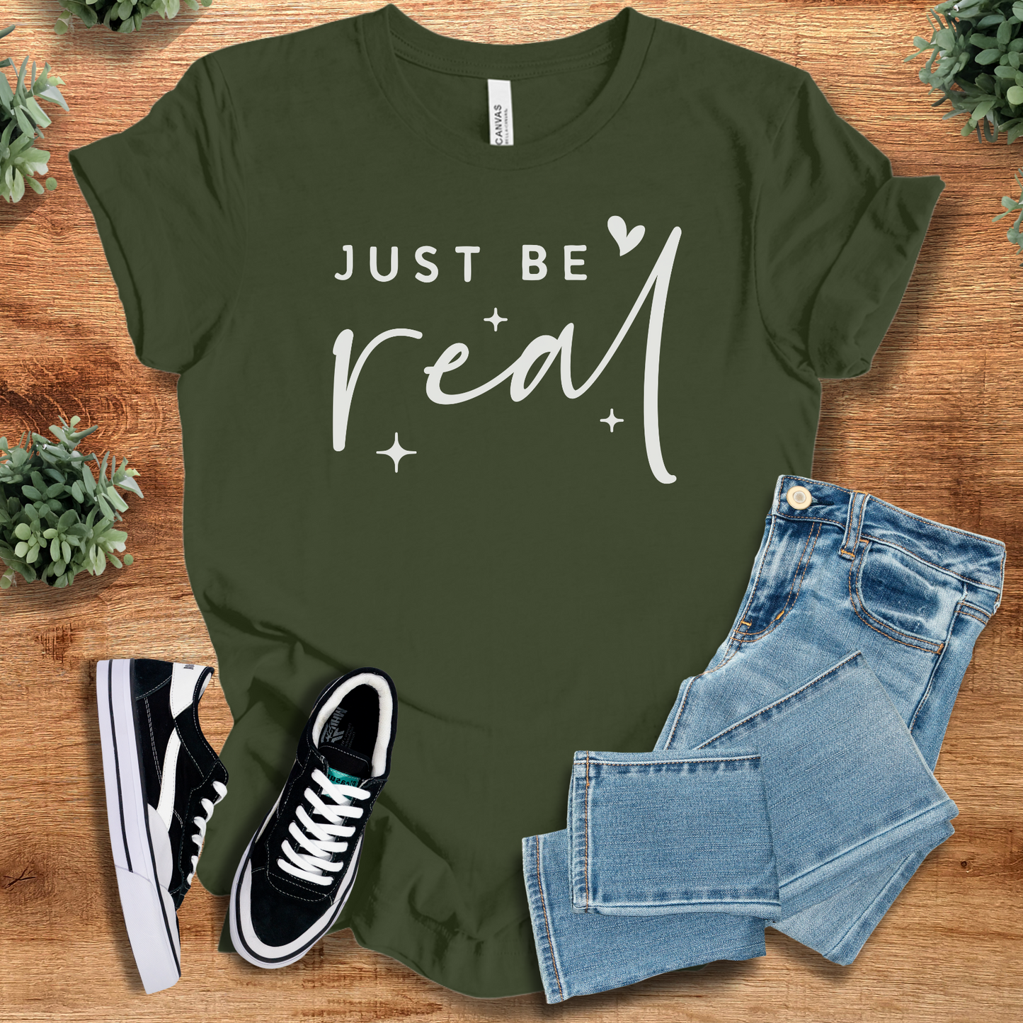 Heather-aqua t-shirt with '' text, flat lay styled on a wooden surface.