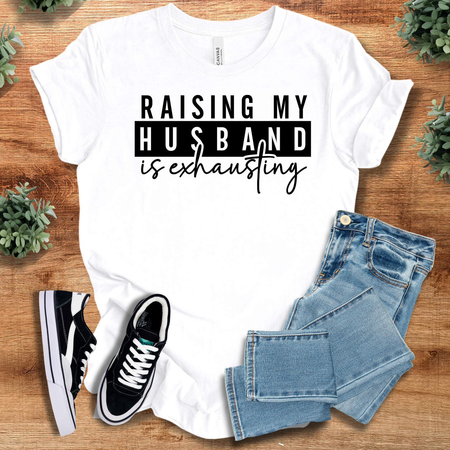 Athletic-heather t-shirt with '' text, flat lay styled on a wooden surface.