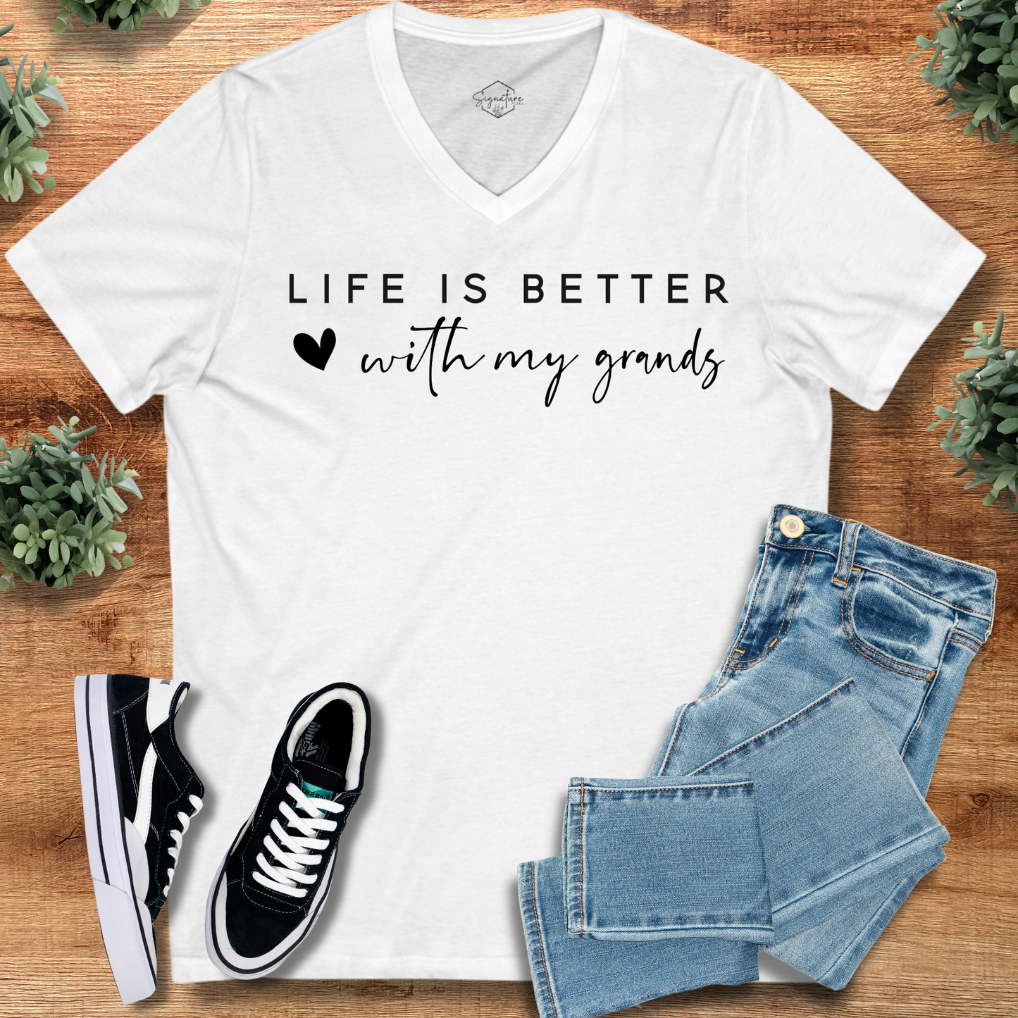 White Grandparents V-Neck Tee with 'Life is Better with My Grands' text, paired with denim and sneakers. Perfect gift for Grandparents Day.