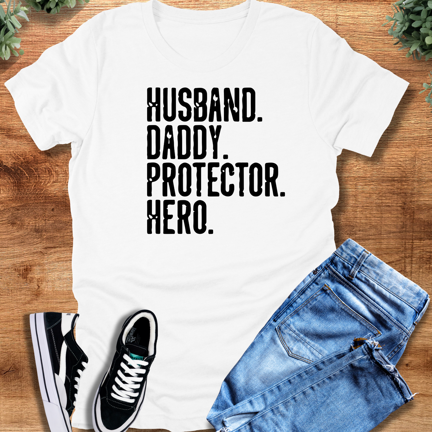 Heather-navy t-shirt with '' text, flat lay styled on a wooden surface.