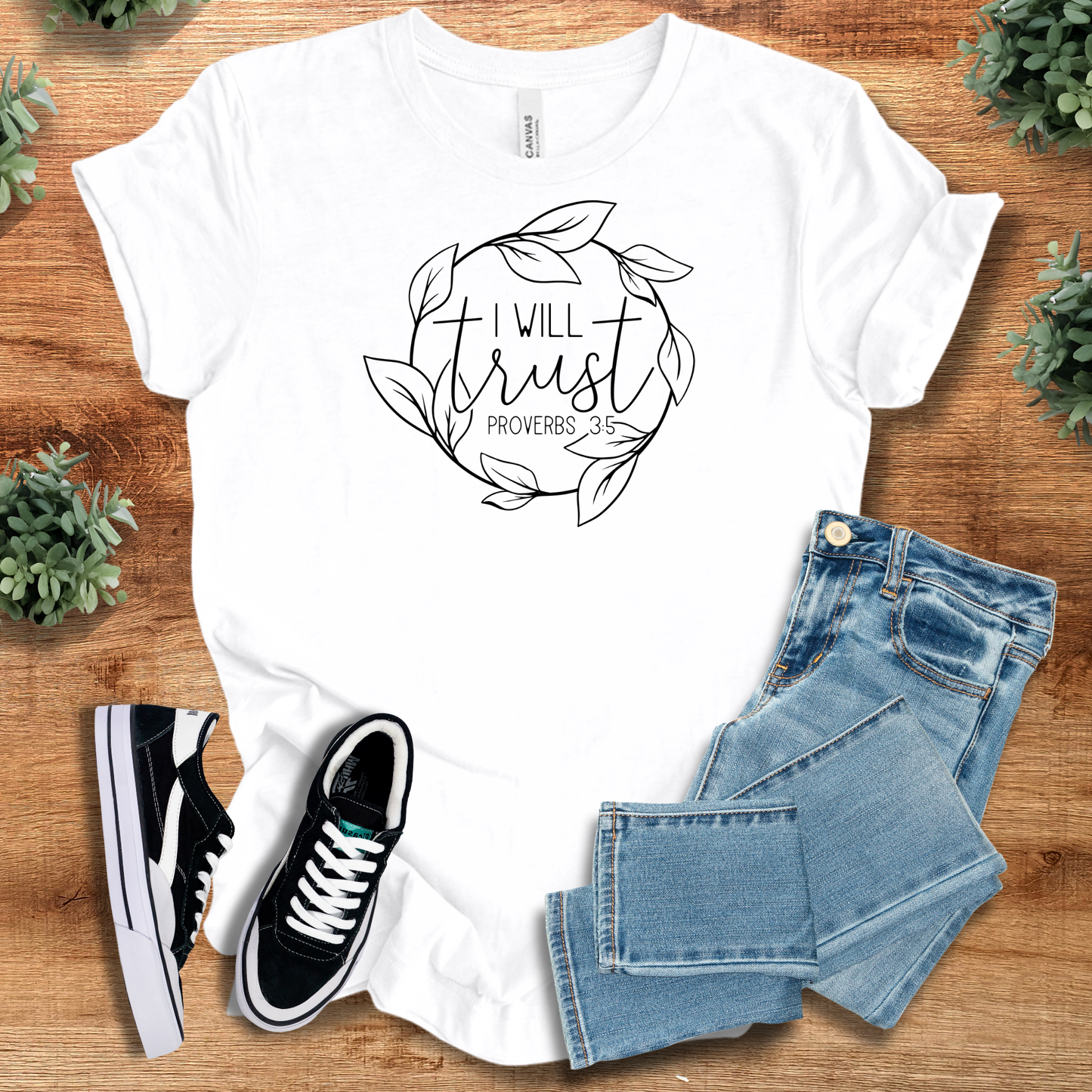 White Trust Proverbs 3:5 Tee with floral wreath and scripture quote, styled with jeans and sneakers. Christian apparel with inspirational message.