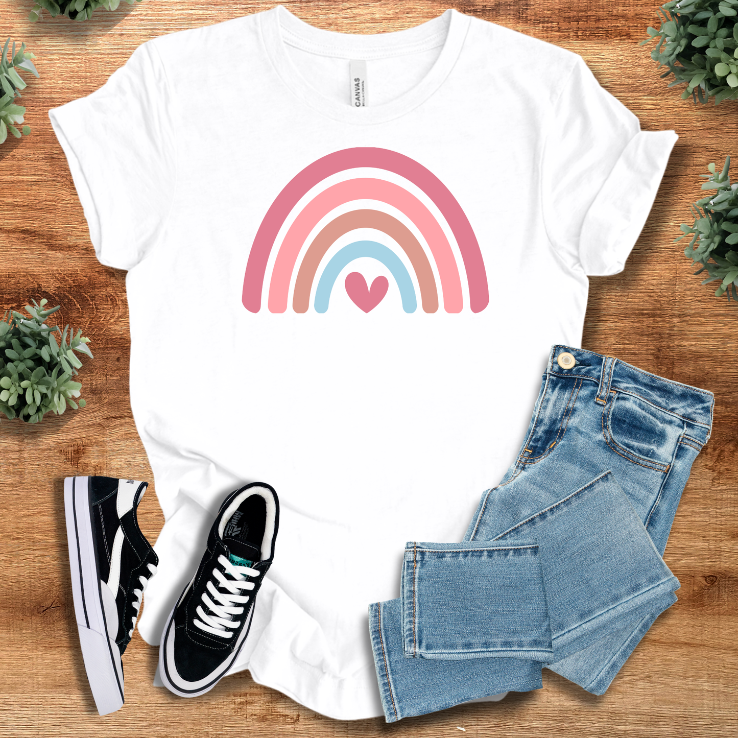 Heart Rainbow Tee in classic white with a pastel rainbow and heart graphic. Lightweight cotton T-shirt great for gifting and everyday style.