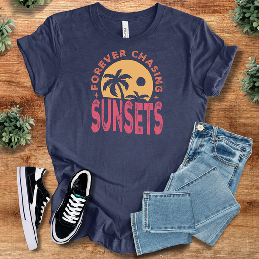Chasing Sunsets Tee in navy blue with palm tree and sunset graphic. Lightweight cotton T-shirt perfect for beach lovers and summer outfits.