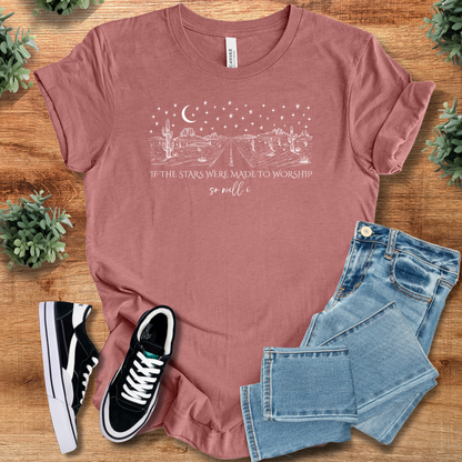 Heather-aqua t-shirt with '' text, flat lay styled on a wooden surface.
