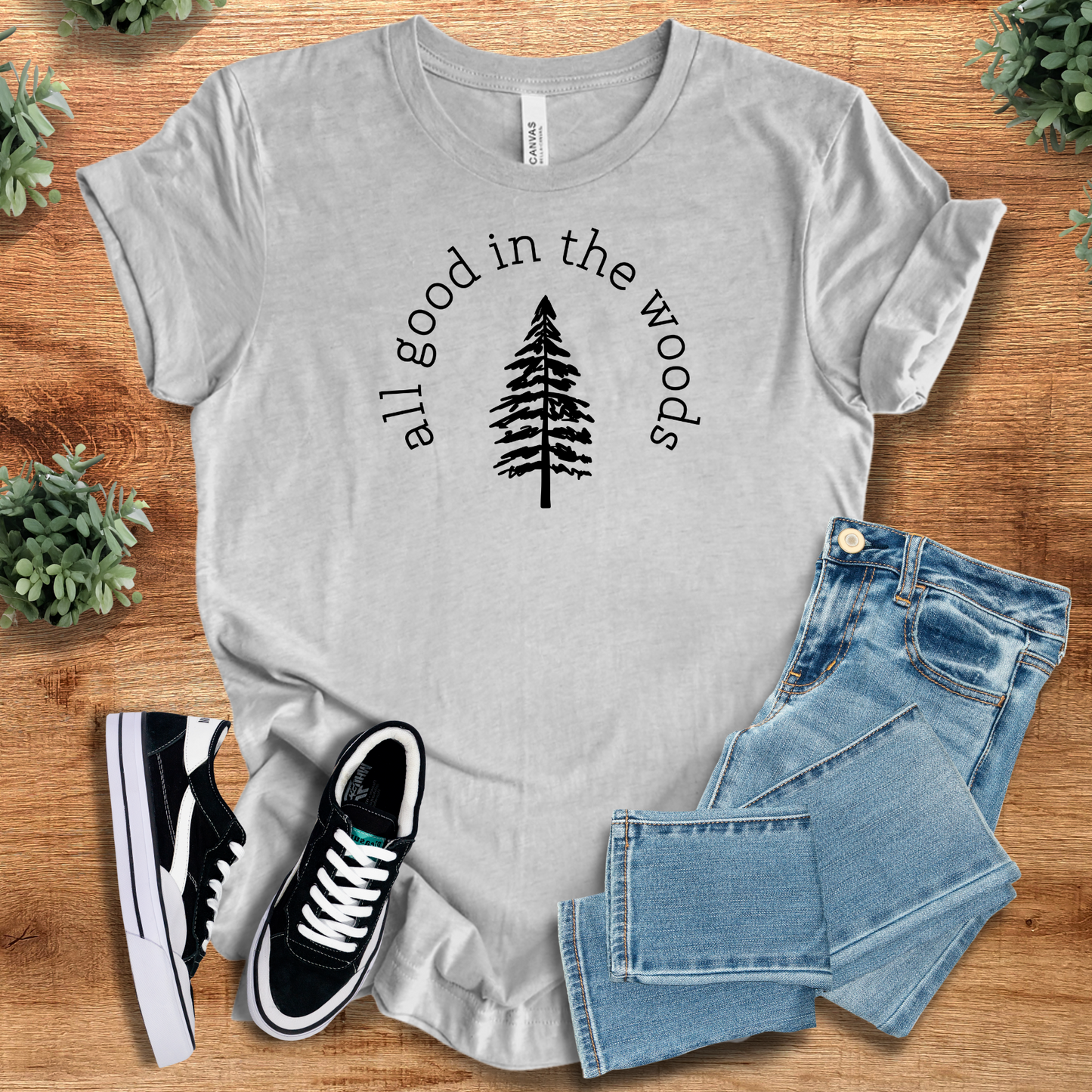 Heather-navy t-shirt with '' text, flat lay styled on a wooden surface.