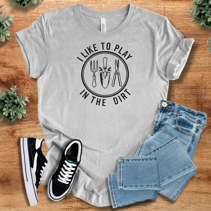 Heather-mauve t-shirt with '' text, flat lay styled on a wooden surface.