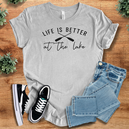 Heather-navy t-shirt with '' text, flat lay styled on a wooden surface.