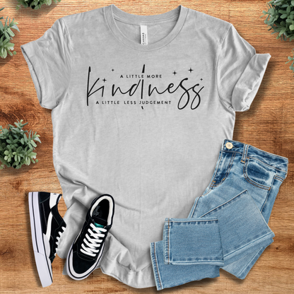 Yellow t-shirt with '' text, flat lay styled on a wooden surface.