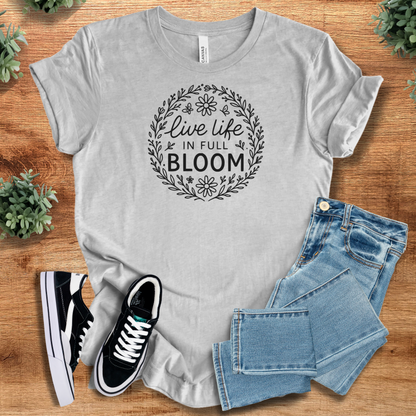 Heather-aqua t-shirt with '' text, flat lay styled on a wooden surface.