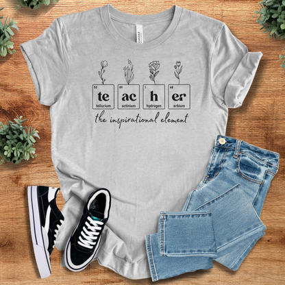 Heather-mauve t-shirt with '' text, flat lay styled on a wooden surface.