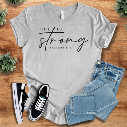 Heather-navy t-shirt with '' text, flat lay styled on a wooden surface.