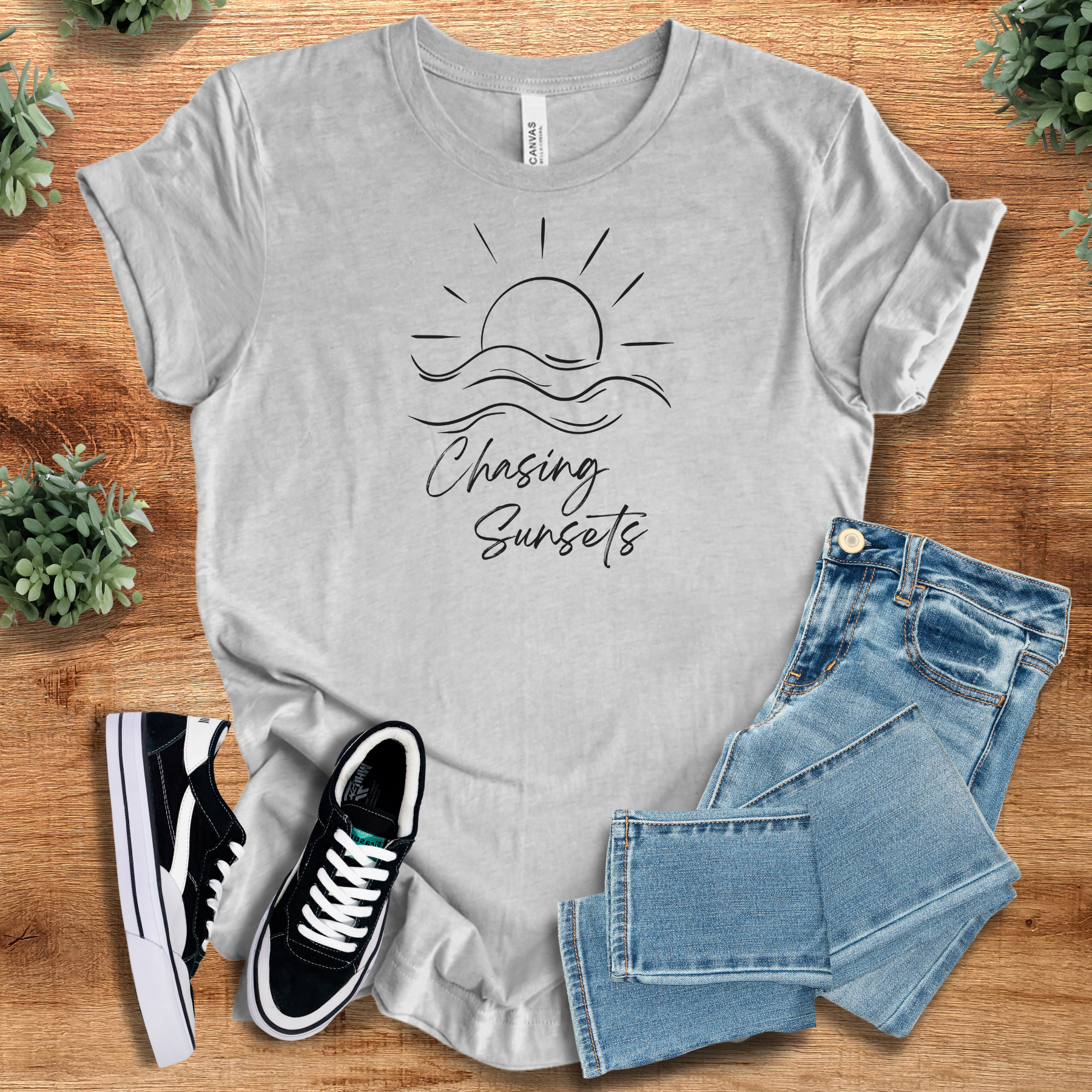 Heather-mauve t-shirt with '' text, flat lay styled on a wooden surface.