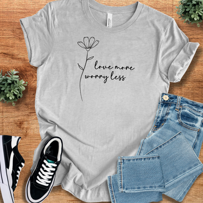 Heather-mauve t-shirt with '' text, flat lay styled on a wooden surface.