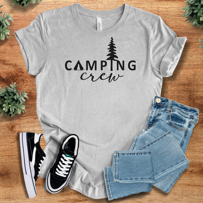 Athletic-heather t-shirt with 'Camping Crew Adventure T‑Shirt' text, flat lay styled on a wooden surface.