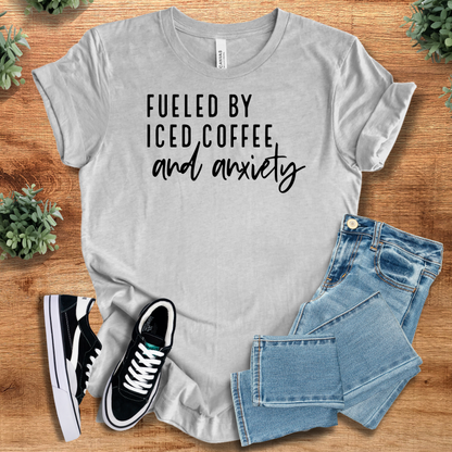Heather-aqua t-shirt with '' text, flat lay styled on a wooden surface.