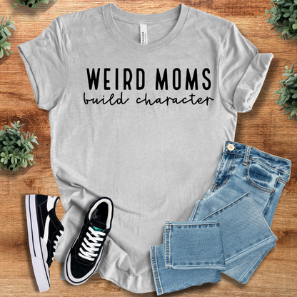 Heather-mauve t-shirt with '' text, flat lay styled on a wooden surface.