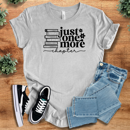 Heather-aqua t-shirt with '' text, flat lay styled on a wooden surface.
