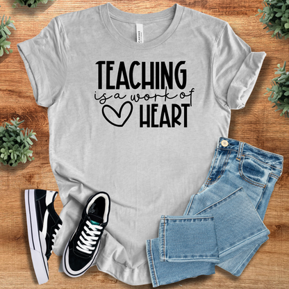 Heather-aqua t-shirt with '' text, flat lay styled on a wooden surface.