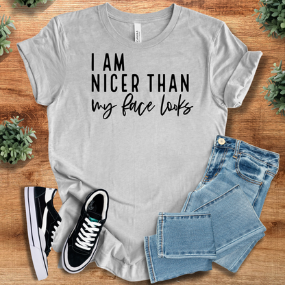 Heather-mauve t-shirt with '' text, flat lay styled on a wooden surface.