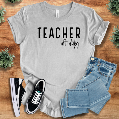 Heather-navy t-shirt with '' text, flat lay styled on a wooden surface.