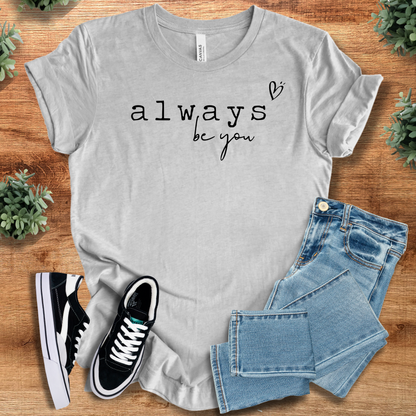 Heather-aqua t-shirt with '' text, flat lay styled on a wooden surface.