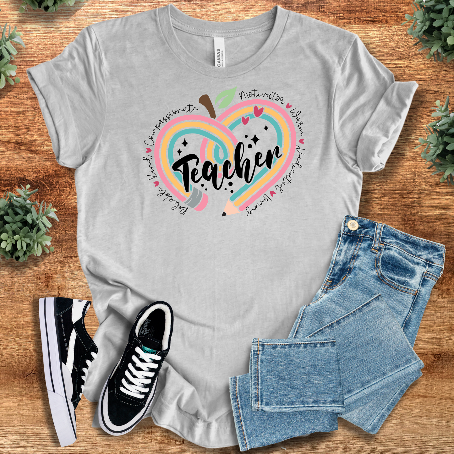 Heather gray Teacher Appreciation T-Shirt featuring a vibrant apple-heart design and inspiring words. Soft cotton tee perfect for teacher gifts.