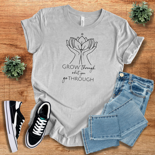 Light gray 'Grow Through What You Go Through' t-shirt with a stylish hands and lotus print. Comfortable, sustainable cotton, perfect for daily wear.