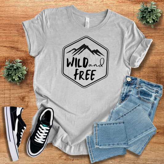Wild and Free unisex t-shirt in light gray with a mountain-themed graphic. Soft cotton, short sleeve, and crew neck for casual comfort.