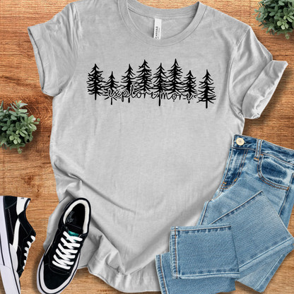 Athletic-heather t-shirt with 'Explore More T‑Shirt' text, flat lay styled on a wooden surface.