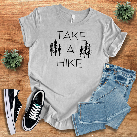 Light gray hiking graphic tee with 'Take A Hike' print and tree design, a stylish and comfortable choice for outdoor lovers.