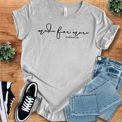Heather-mauve t-shirt with '' text, flat lay styled on a wooden surface.