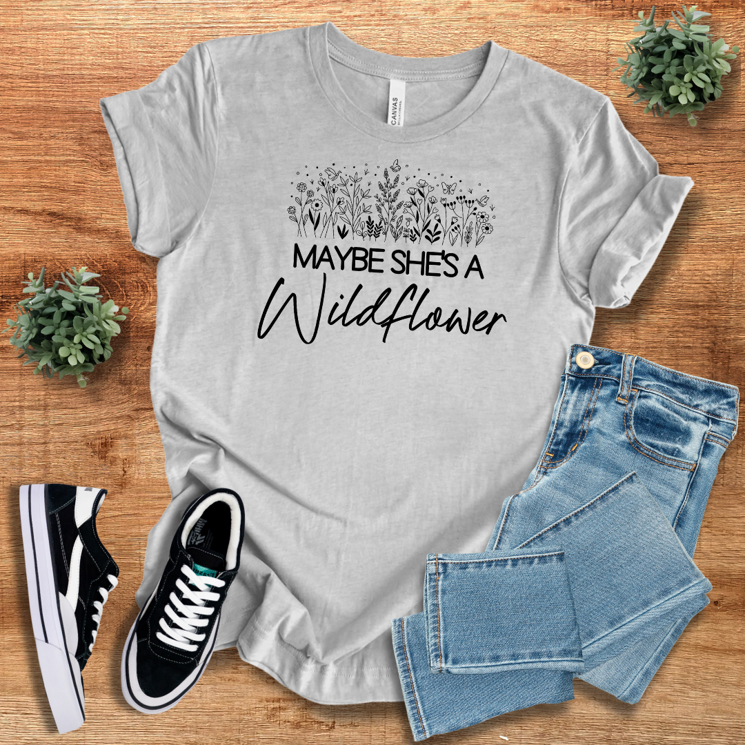 Heather gray wildflower graphic tee with 'Maybe She's a Wildflower' text, offering a soft and comfortable fit. A perfect casual wear option for nature lovers.