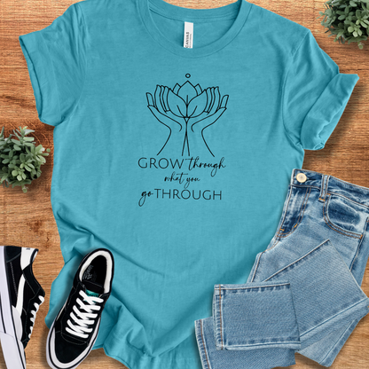 Athletic-heather t-shirt with '' text, flat lay styled on a wooden surface.