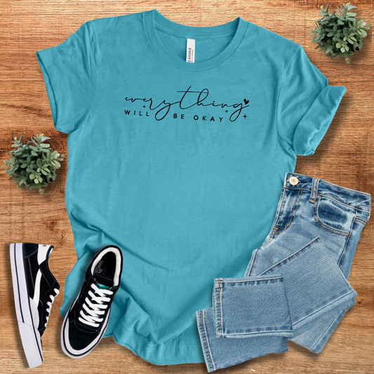 Teal 'Everything Will Be Ok' t-shirt with black script text, laid out with jeans and sneakers. A breathable and relaxed fit unisex casual tee.