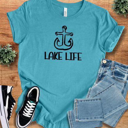 Heather-aqua t-shirt with 'Lake Life Minimalist Graphic T‑Shirt' text, flat lay styled on a wooden surface.