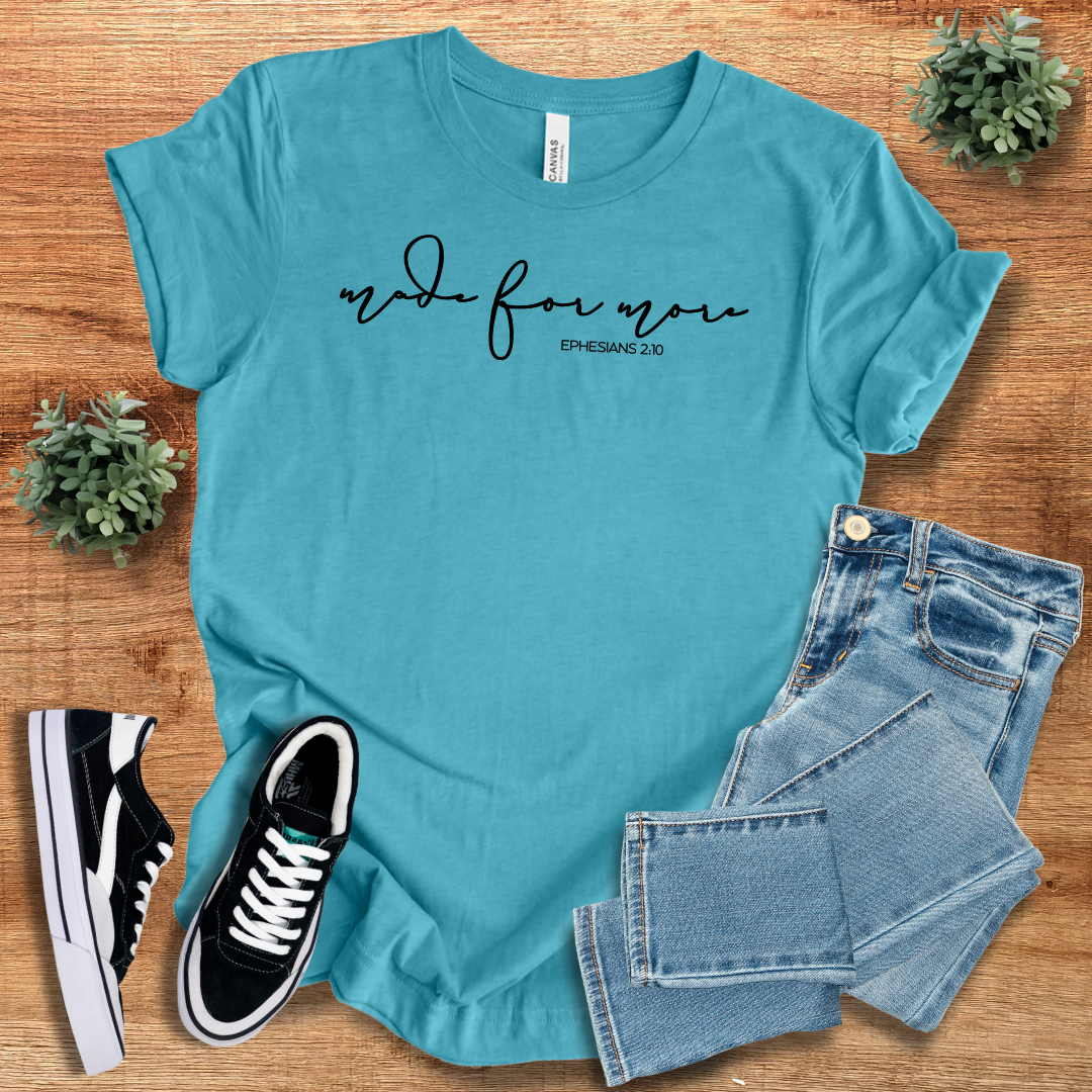 Bright turquoise Made for More Graphic Tshirt with black script text, styled with jeans and sneakers. A vibrant and comfortable casual top.