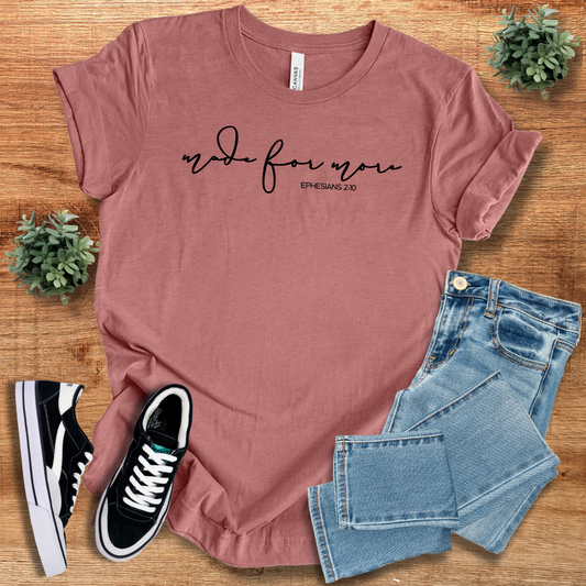Dusty rose Made for More Graphic Tshirt with black script text, styled with jeans and sneakers. A soft, stylish, and gender-neutral casual tee.
