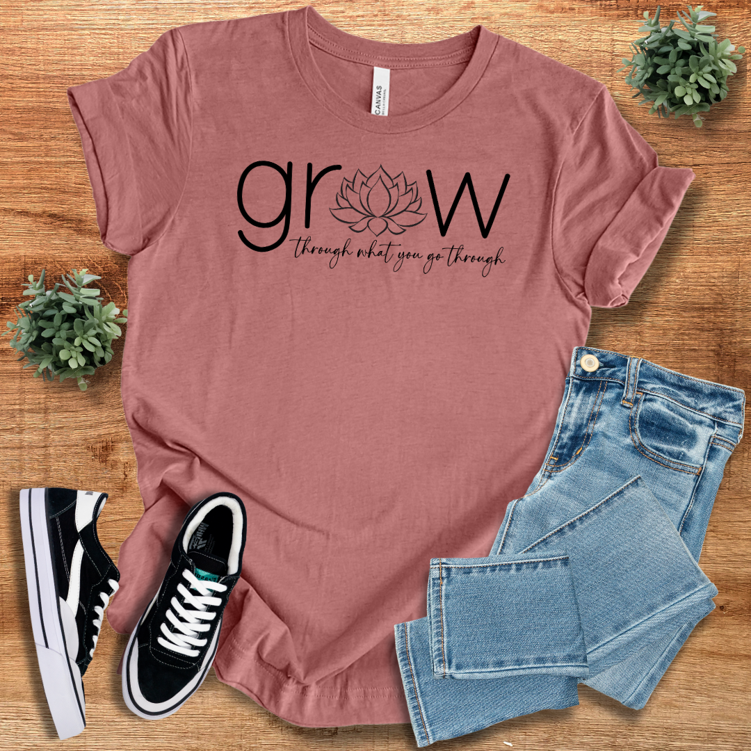Mauve 'Grow Through What You Go Through' t-shirt featuring a lotus flower design. Comfortable cotton fabric, unisex fit, ideal for everyday wear.