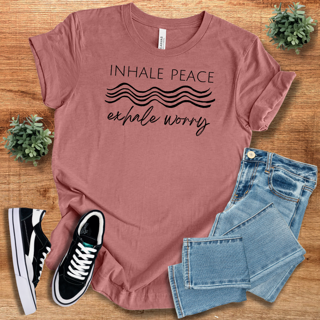 Mauve 'Inhale Peace Exhale Worry' t-shirt with black script design. Soft, eco-friendly cotton with a relaxed fit for comfortable living.