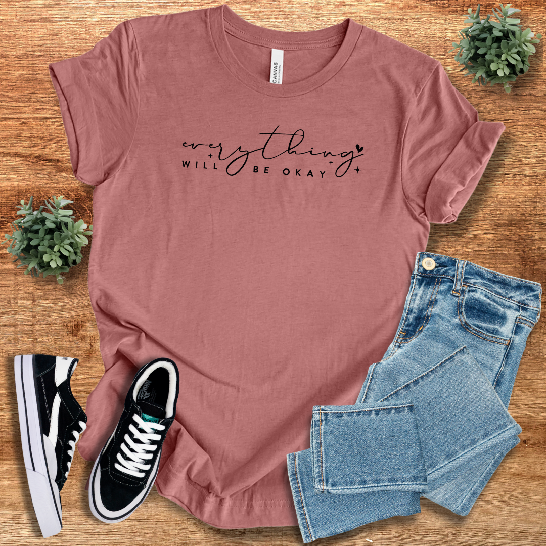 Mauve 'Everything Will Be Ok' t-shirt with black script text, styled with denim jeans and sneakers. A breathable and relaxed fit casual tee.