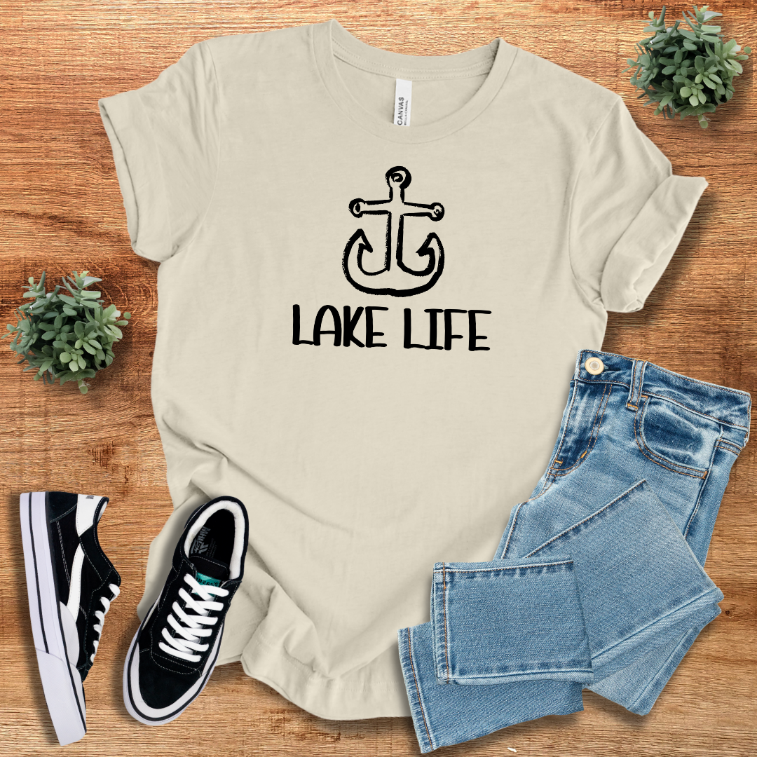 Cream-colored Lake Life Graphic Tee featuring a black anchor design, a relaxed fit shirt for summer adventures.