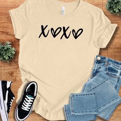 Heather-mauve t-shirt with '' text, flat lay styled on a wooden surface.