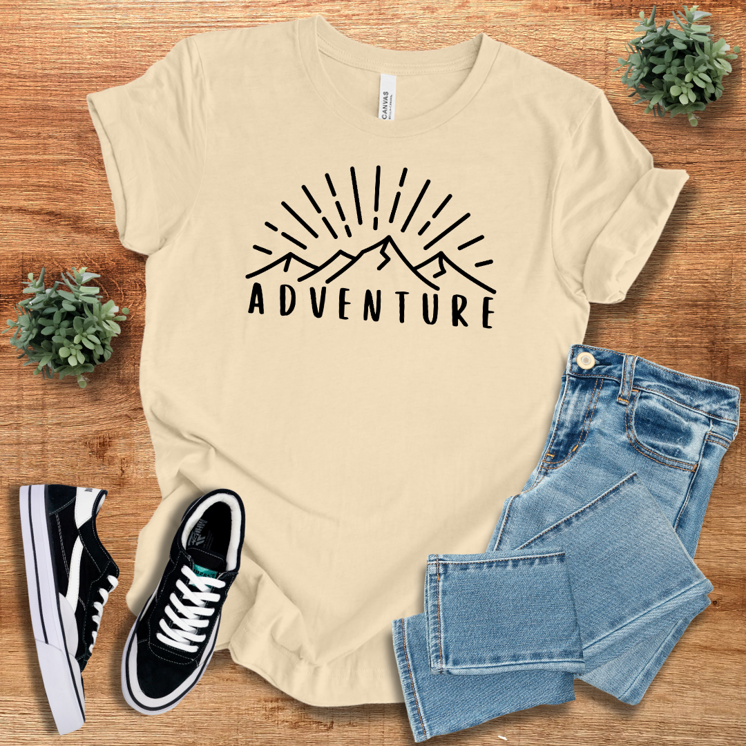Beige adventure graphic t-shirt with a minimalist mountain silhouette. Ideal for hiking, travel, and everyday wear.