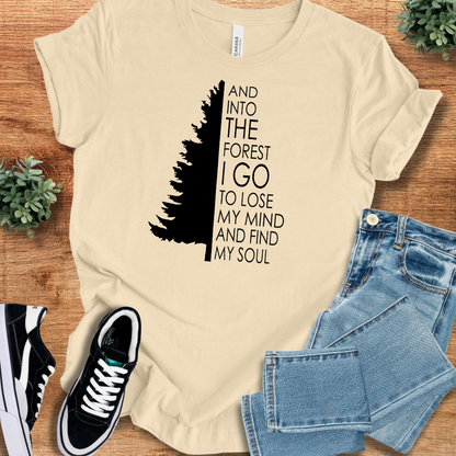 Heather-mauve t-shirt with '' text, flat lay styled on a wooden surface.